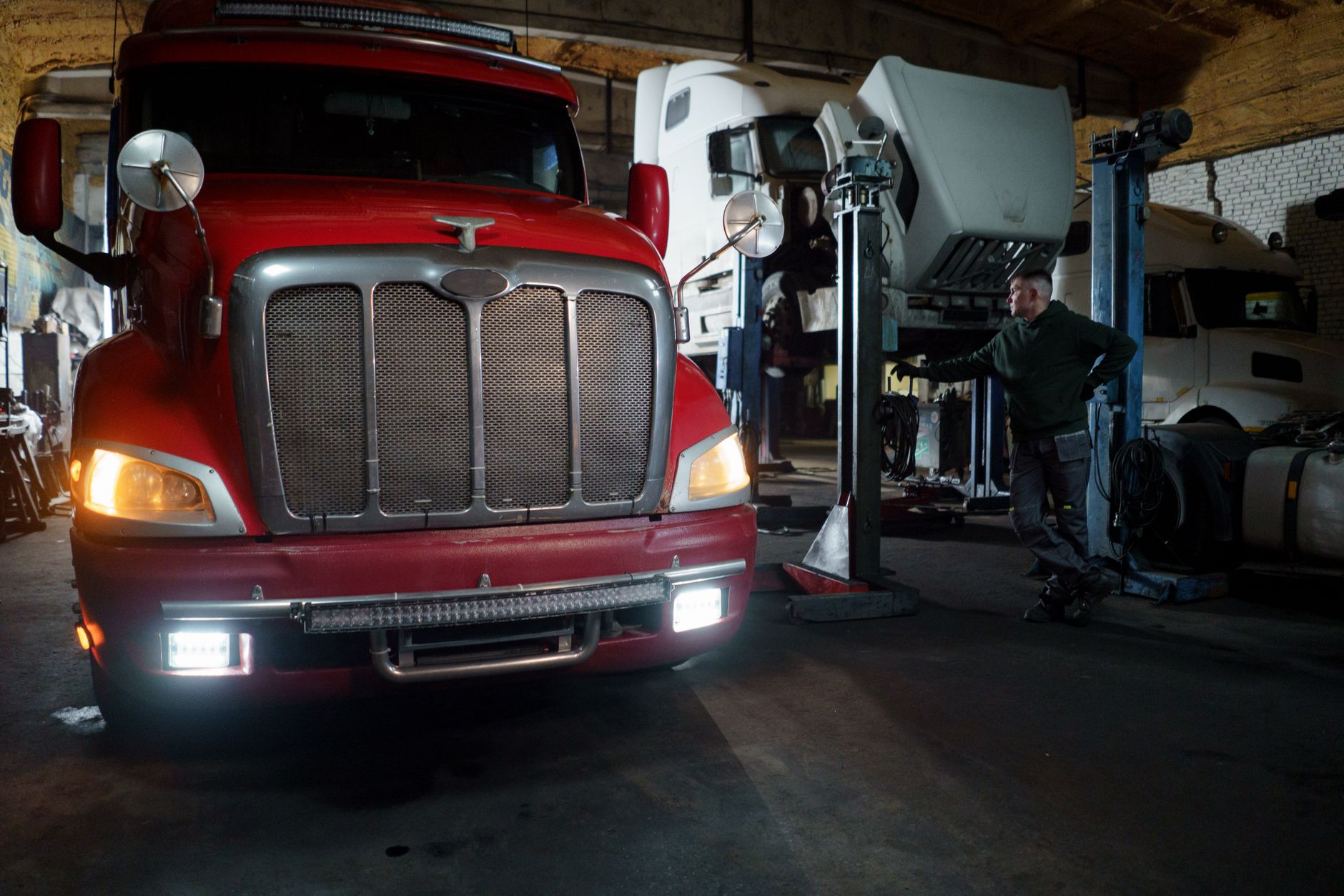 Truck elevated on a lift in a repair garage for maintenance