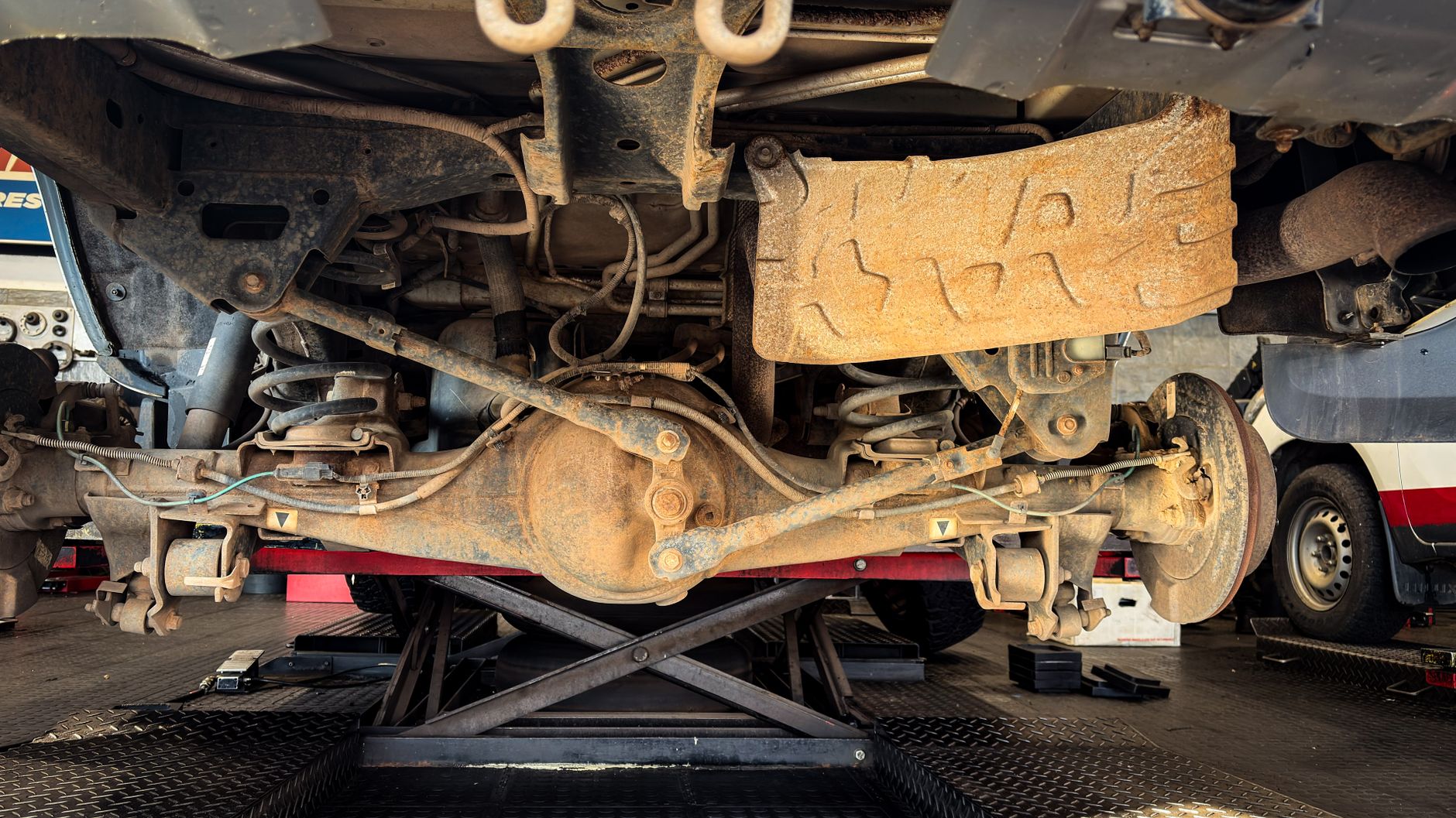 Suspension components exposed on a car during repair on a lift